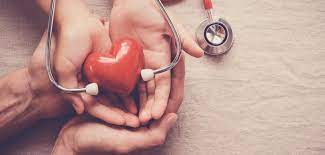 two peoples hands and a stethoscope, all clasping a heart shape