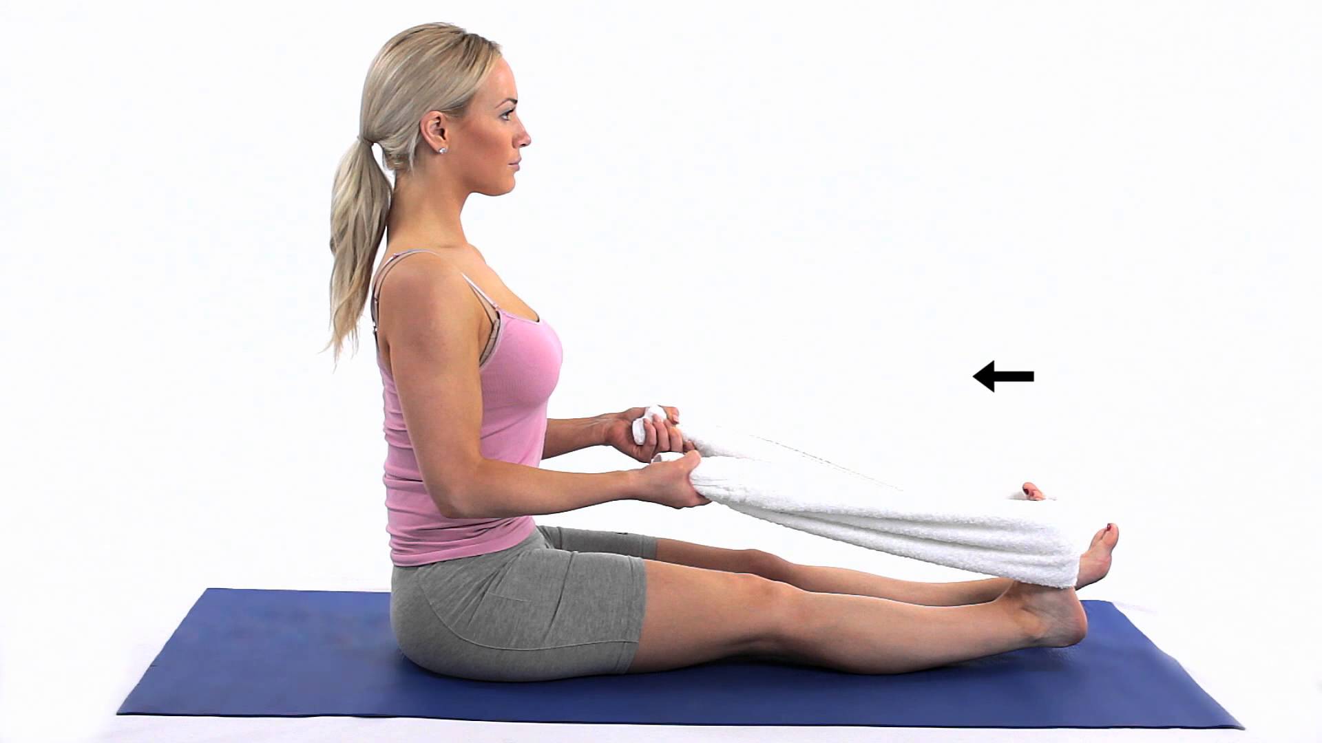 a lady sitting down using a towel around one foot and held in both hands, showing a stretch